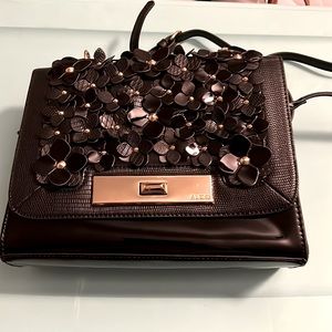 Black and gold flower design Aldo shiny black purse . Good condition.